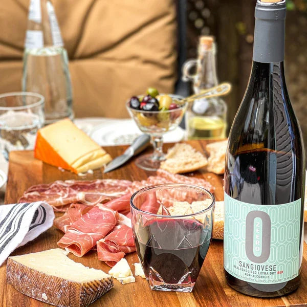 Charcuterie dinner table setting with dealcoholized wine and wine glasses