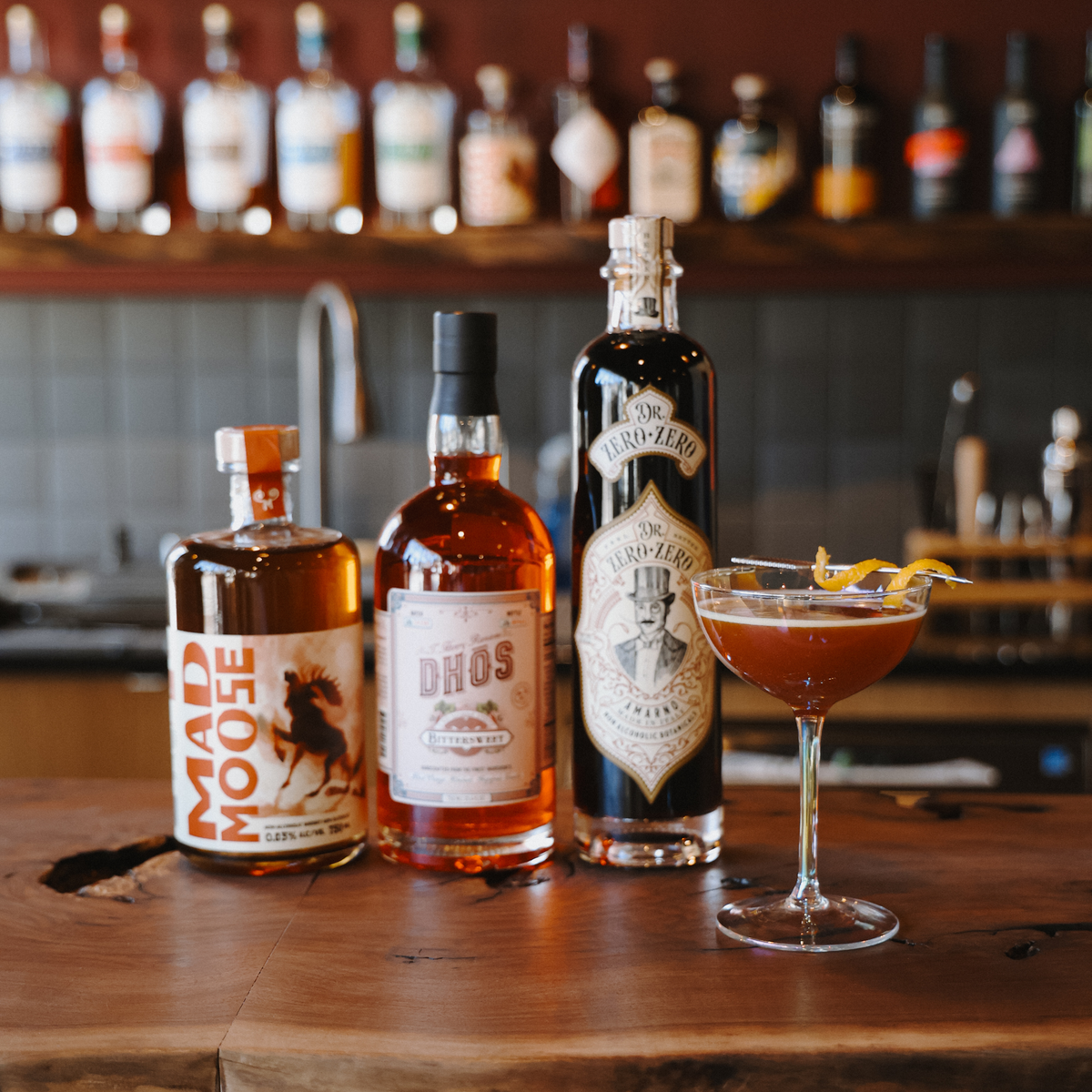 Mad Moose on a Paper Plane zero-proof cocktail with lemon wheel garnish in coupe